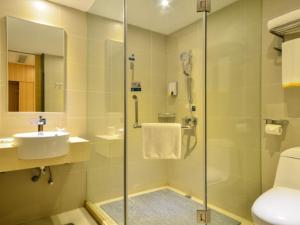 a bathroom with a shower and a sink and a toilet at City Comfort Inn Wuhan South Lake Zhongnan University of Economics and Law Fashion City in Liufangling