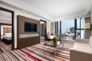 a hotel room with a bed and a large window at Novotel Nanjing Central in Nanjing