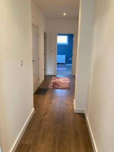 an empty room with a hallway with wood floors at Promotion Half Price 2 Bedroom Flat in West Ealing in London