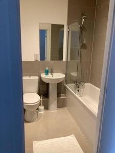 a bathroom with a toilet and a sink and a tub at Promotion Half Price 2 Bedroom Flat in West Ealing in London