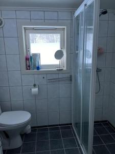 a bathroom with a shower and a toilet and a window at Sentrumsnært hus in Rjukan +14 photos