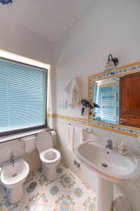 a bathroom with a toilet and a sink at Nido Degli Dei in Agerola