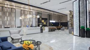 a lobby with couches and chairs and a bar at Echarm Hotel Baise Xilin 
