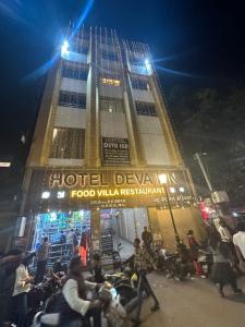 a group of people standing in front of a building at HOTEL DEVA INN in Varanasi