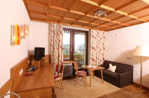 a living room with a couch and a table at Hotel Sonnentau in Fladungen