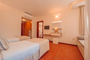 a hotel room with two beds and a television at Sundia By Liberty Suncity in Oludeniz