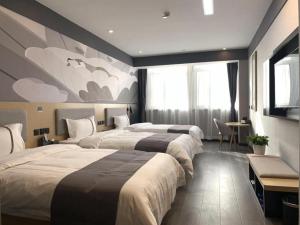 a hotel room with two beds and a tv at Thank Inn Ningxia Yinchuan Helan County Ningxia Jiaotong School in Yinchuan