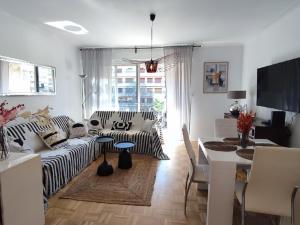 a living room with a couch and a table at Cosy Vertigo apartment behind the hotel Martinez in Cannes