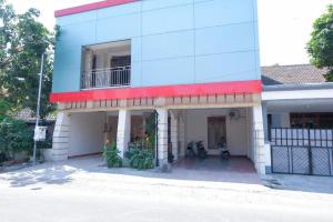 a blue and white building with a balcony at Hotel Welirang Syariah in Kediri