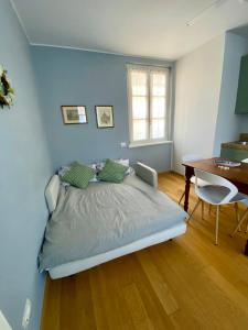 a bedroom with a bed and a table and a desk at La casa di Beatrice e Francesca in Turin