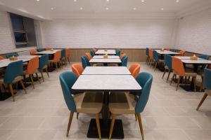 a dining room with tables and chairs at Hanting Hotel Heze Zhonghua Road Ginza in Heze