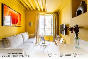 sala de estar con sofá y mesa en Beauquartier - Marais, Bourg Tibourg en París