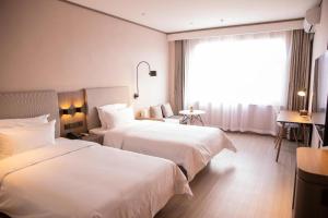 En eller flere senger på et rom på Hanting Hotel Hohhot Jinqiao Development Zone