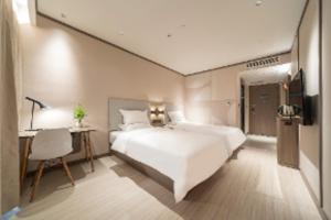 Krevet ili kreveti u jedinici u okviru objekta Hanting Hotel Shanghai Fengxian Xincheng Nanfeng Road