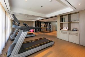 a gym with several tread machines in a room at Ji Hotel Wenzhou Economic Development Zone Binhai Park in Xingqianjie