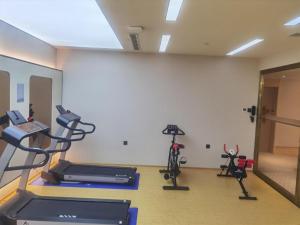 a gym with two treadmills and two exercise bikes at Ji Hotel Chuangchun Railway Station in Changchun