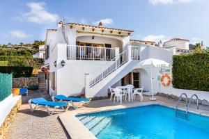 a villa with a swimming pool and a house at Villa Ponent in Son Bou