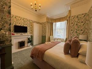 a bedroom with a large bed and a fireplace at Sonas Guesthouse in Edinburgh