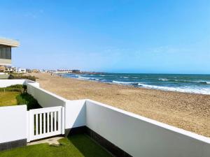 a view of the beach from the balcony of a beach house at Camere da Letto ON-THE-BEACH Self Catering in Swakopmund