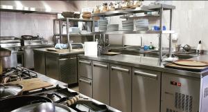 a large kitchen with stainless steel counters and appliances at Gavdos Panorama in Gavdos