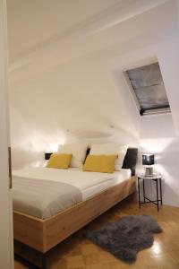 a bedroom with a large bed with yellow pillows at Arena Apartments in Graz