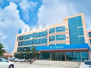 a large office building with a blue sign on it at Hanting Hotel Jiaozhou Jiaodong International Airport in Madian