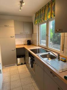 una pequeña cocina con fregadero y ventana en Wohnung in idyllischer Lage en Ammerbuch