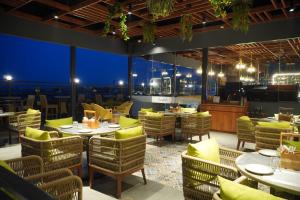 a restaurant with tables and chairs with a view at Mastiff Hotel Dhanbad in Dhanbād