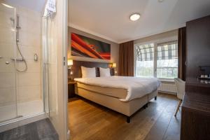 Postel nebo postele na pokoji v ubytování Fletcher Hotel-Restaurant Arneville-Middelburg