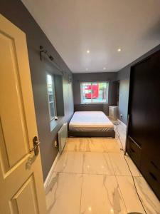 a bedroom with a bed and a window and a door at Promotion, Half Price 1 Bed Flat By Richmond Park in London