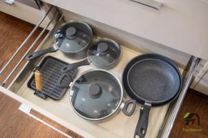 a stove top with four pans on top of it at 'Lynwood' Warrawee Manor- Koi Home in Warrawee