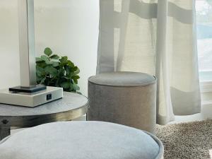 a chair sitting next to a table and a window at Large Renovated Cottage on East Lake Park in Birmingham +32 photos