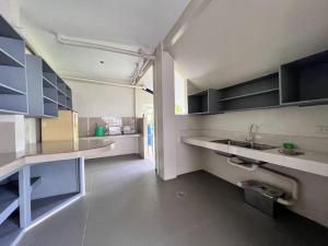 a kitchen with a sink and a counter top at Oslob Seacoast Resort in Oslob