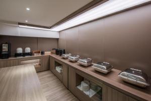 a room with a counter with food containers on it at Hanting Hotel Wuzhong Wanda Plaza in Wuzhong