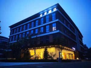a large building with lights on it at night at Ji Hotel Daxing Biomedical Base Hotel in Daxing