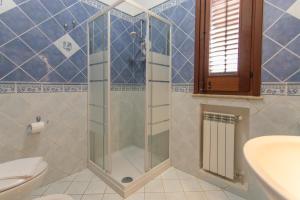 a bathroom with a shower and a toilet and a sink at Dammuso Ignazio in Lampedusa
