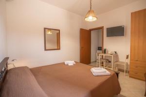 a bedroom with a bed with two towels on it at Dammuso Ignazio in Lampedusa
