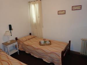מיטה או מיטות בחדר ב-Las Heras Hotel
