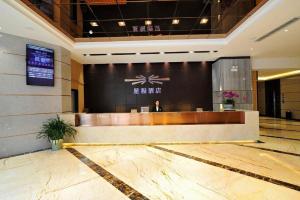 a lobby with a reception desk in a building at Starway Hotel Guiyang Big Cross in Guiyang