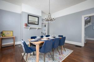 a dining room with a table and blue chairs at Magic on 17th Street- Historic, Close to UAB, UAB Hospital in Birmingham