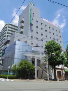 a large building with a reflection of a building at Minami Fukuoka Green Hotel in Fukuoka