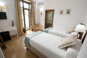 Postel nebo postele na pokoji v ubytování Hotel San Miguel