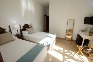 Postel nebo postele na pokoji v ubytování Hotel San Miguel