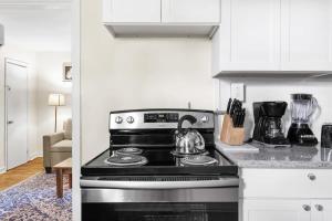 a kitchen with a stove with a tea kettle on it at The Bricks - Apt 1 in Birmingham