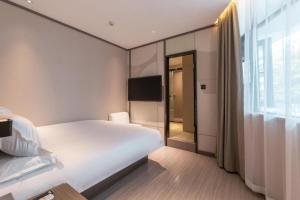 Krevet ili kreveti u jedinici u okviru objekta Hanting Hotel Xiamen Airport Chenggong Avenue