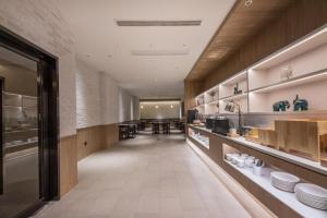 a large kitchen with a long hallway with white dishes at Hanting Hotel Nantong Railway Station in Nantong