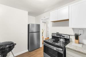 a kitchen with a black stove and a refrigerator at The Bricks - Apt 3 in Birmingham