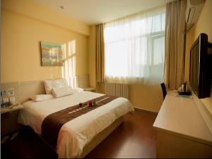 Säng eller sängar i ett rum på Elan Boutique Hotel Yinchuan Xinhua West Street