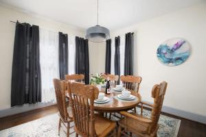 a dining room with a wooden table and chairs at East Lake Stunner-Located at the foot of the Ruffner Mountains in Birmingham