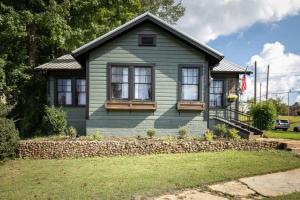 uma pequena casa verde com janelas e uma bandeira em East Lake Stunner-Located at the foot of the Ruffner Mountains em Birmingham